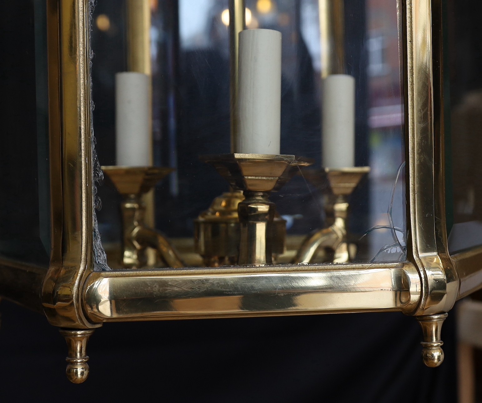 A large Georgian style hexagonal brass hall lantern with bevelled glass plates, height 79cm. width 48cm